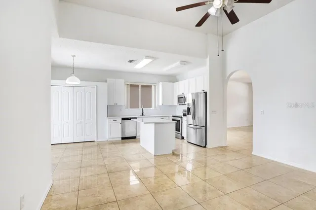 a kitchen with a sink cabinets and stainless steel appliances