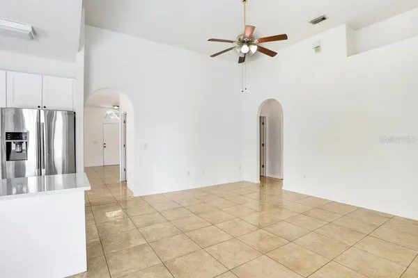 a view of a kitchen with a sink and a refrigerator