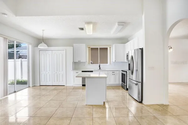 a kitchen with a refrigerator and cabinets