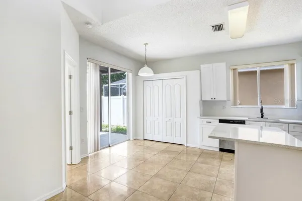 a view of a kitchen with a sink cabinets and a window