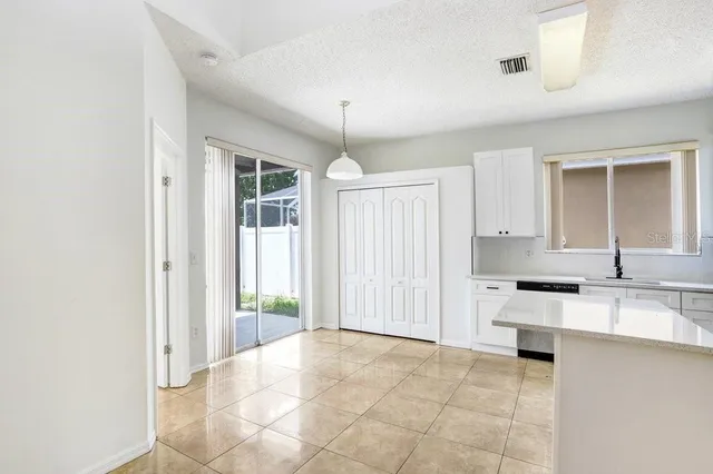 a view of a kitchen with a sink cabinets and a window
