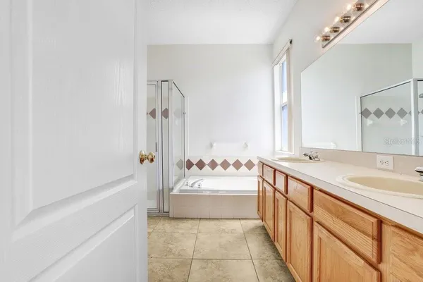 a bathroom with a sink mirror vanity and bathtub