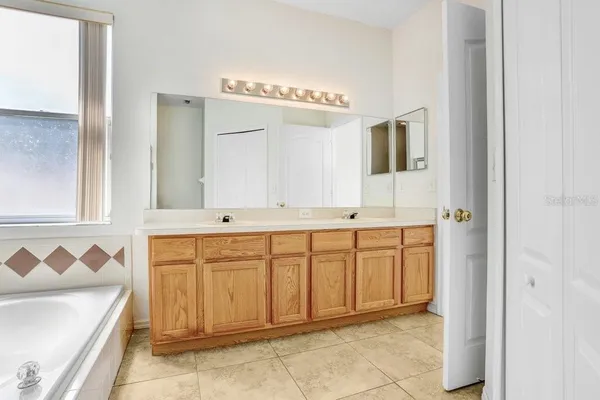 a spacious bathroom with a sink and a mirror