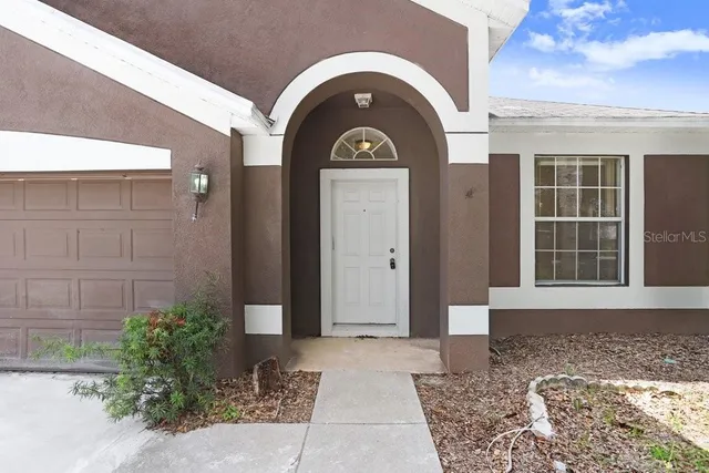 a view of a brick house with a large windows