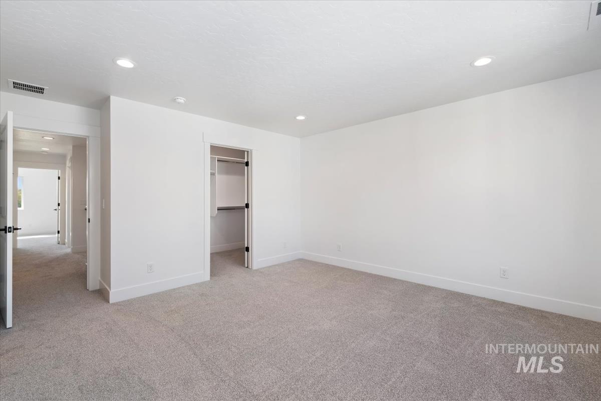 768 South Calhoun Lane Star, ID 83669 - Photo 18 of 36 Spacious room featuring neutral carpeting, recessed lighting, white baseboards, and a built-in closet with shelving