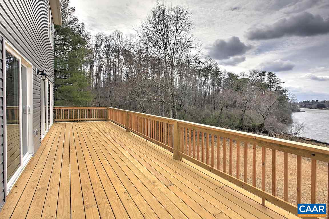 663 Pine Bluff Road Ruckersville, VA 22968 - Photo 15 of 24 a view of balcony with wooden floor and fence and floor to ceiling window