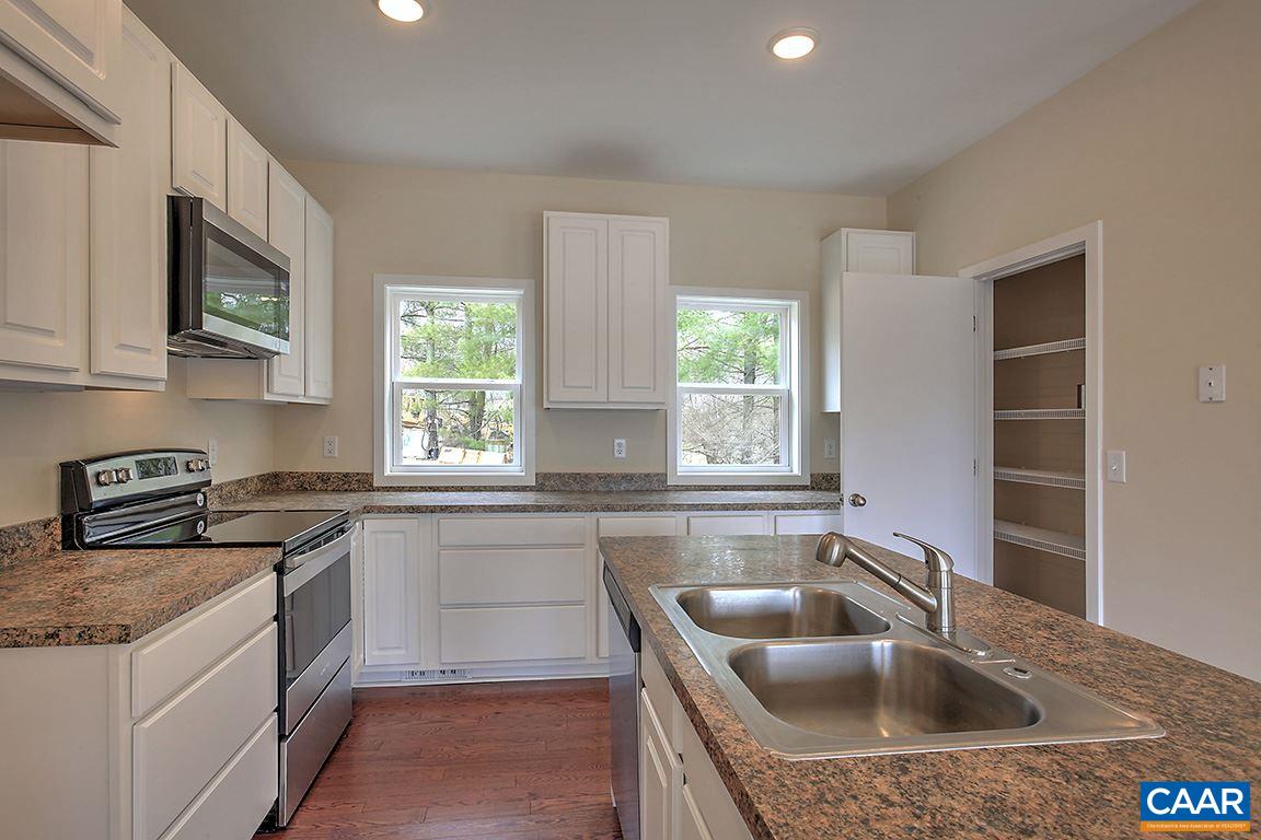 663 Pine Bluff Road Ruckersville, VA 22968 - Photo 8 of 24 a kitchen with granite countertop a sink a stove and cabinets