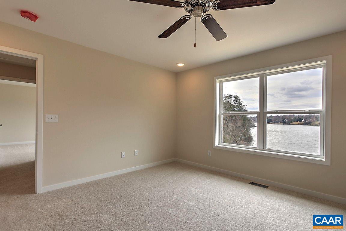 663 Pine Bluff Road Ruckersville, VA 22968 - Photo 10 of 24 an empty room with windows and fan