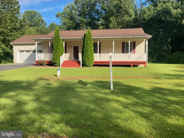 a house view with a sitting space and garden