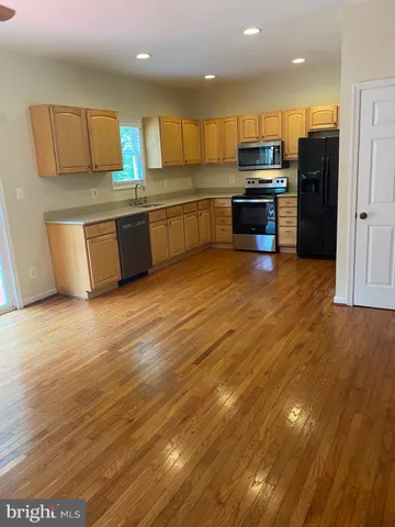a kitchen with stainless steel appliances granite countertop a sink and a stove