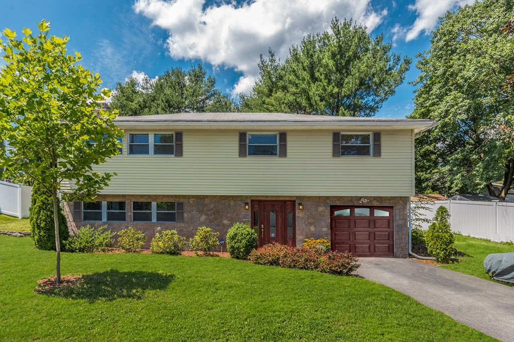 99 Damon Road Needham, MA 02494 - Photo 1 of 1 a view of a brick house with a yard potted plants and large tree