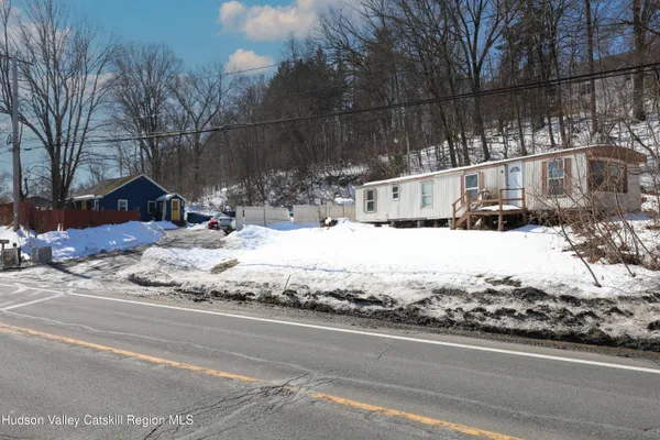 a view of a house with snow on the road