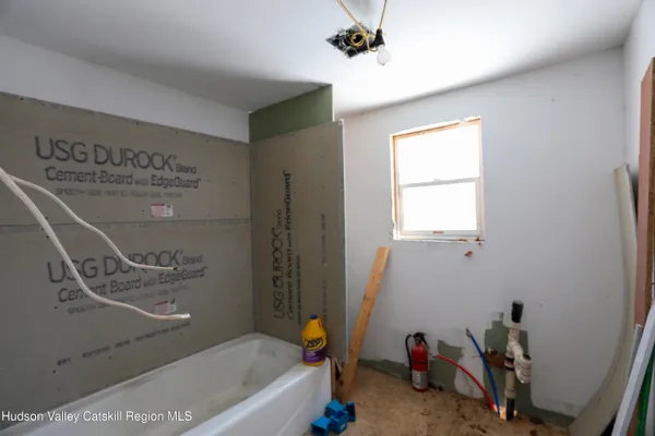 a bathroom with a bathtub a sink and a window