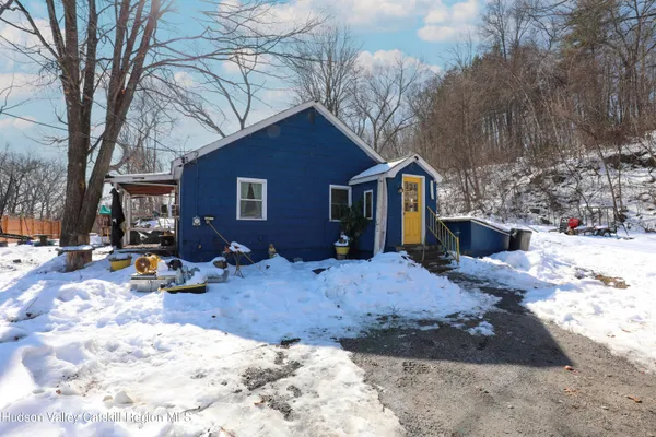 a view of a house with a yard covered in snow