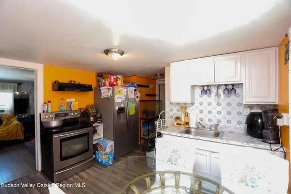 a kitchen with stainless steel appliances kitchen island granite countertop a refrigerator and a stove top oven