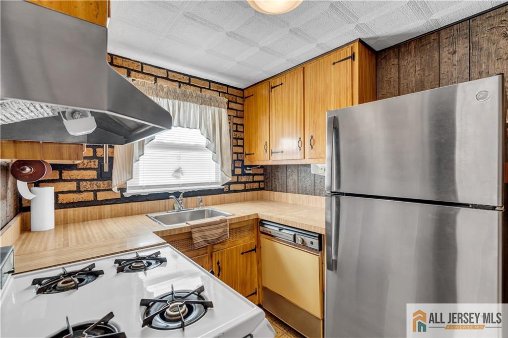 191 Rose Street Metuchen, NJ 08840 - Photo 13 of 20 a white refrigerator freezer sitting inside of a kitchen