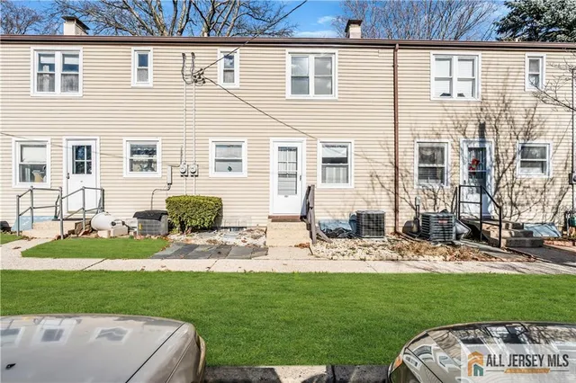 a view of a backyard with couches plants and large tree