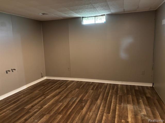 3901 West Lovejoy Road Byron, MI 48418 - Photo 18 of 19 Basement featuring dark wood-style floors and baseboards