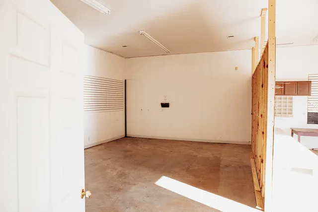 a front view of a house with a garden and garage
