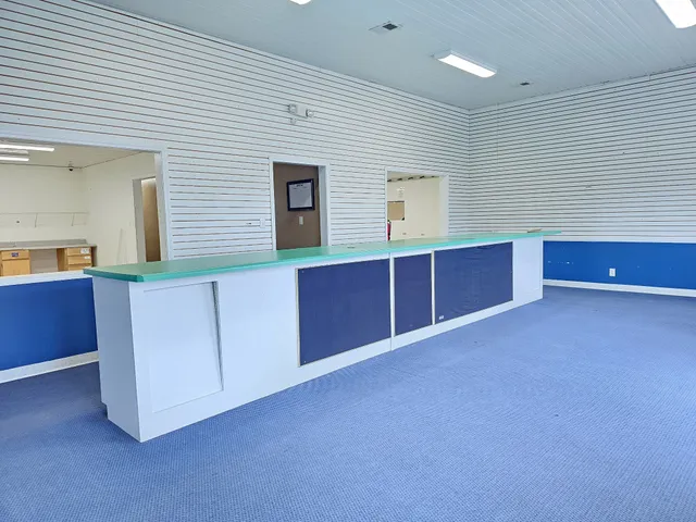a kitchen with stainless steel appliances granite countertop a sink and a large window