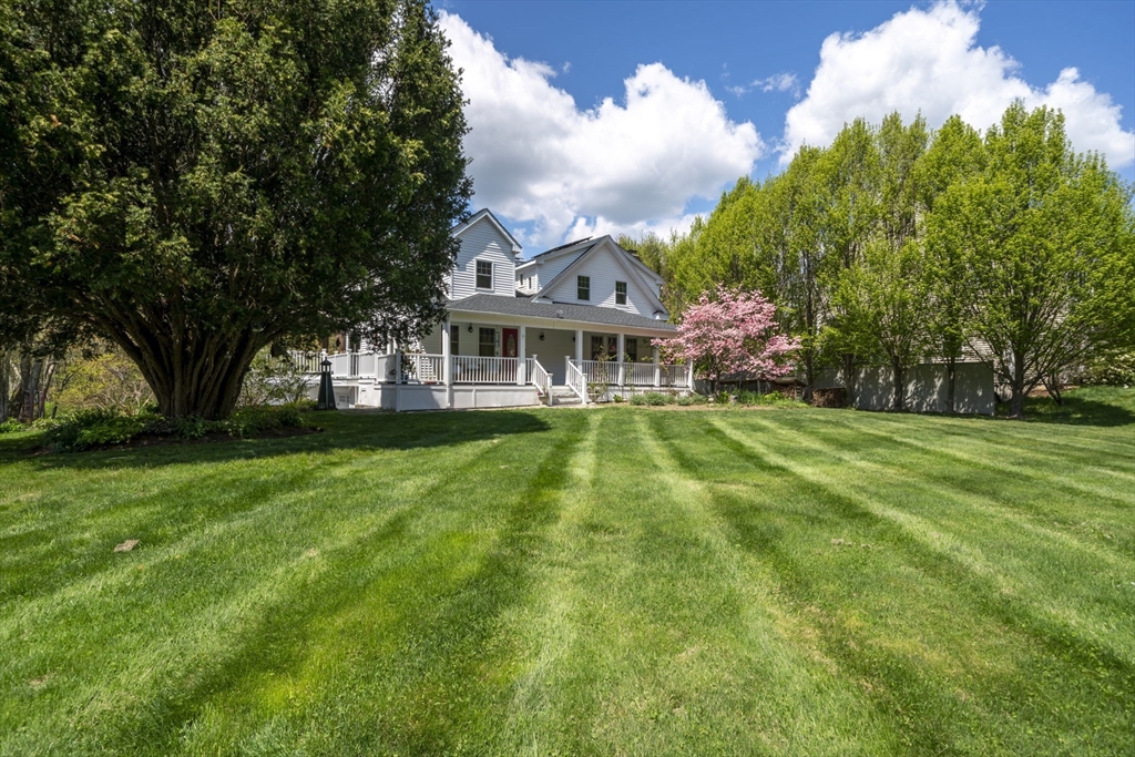 229 Parkerville Road Southborough, MA 01772 - Photo 1 of 38 a view of house in front of a big yard with large trees
