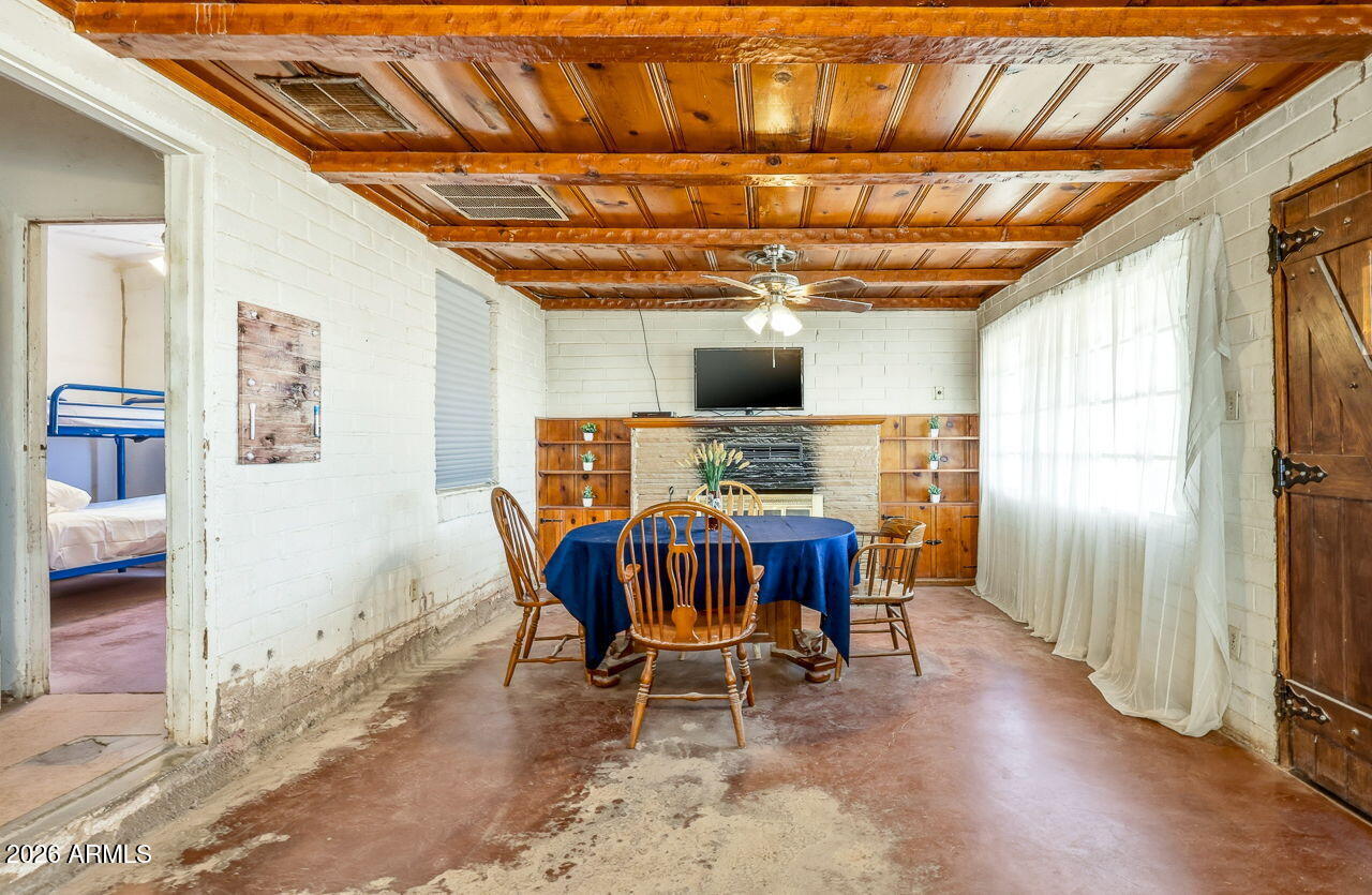 3384 East Cornman Road Casa Grande, AZ 85194 - Photo 33 of 58 a view of a dining room with furniture window and wooden floor