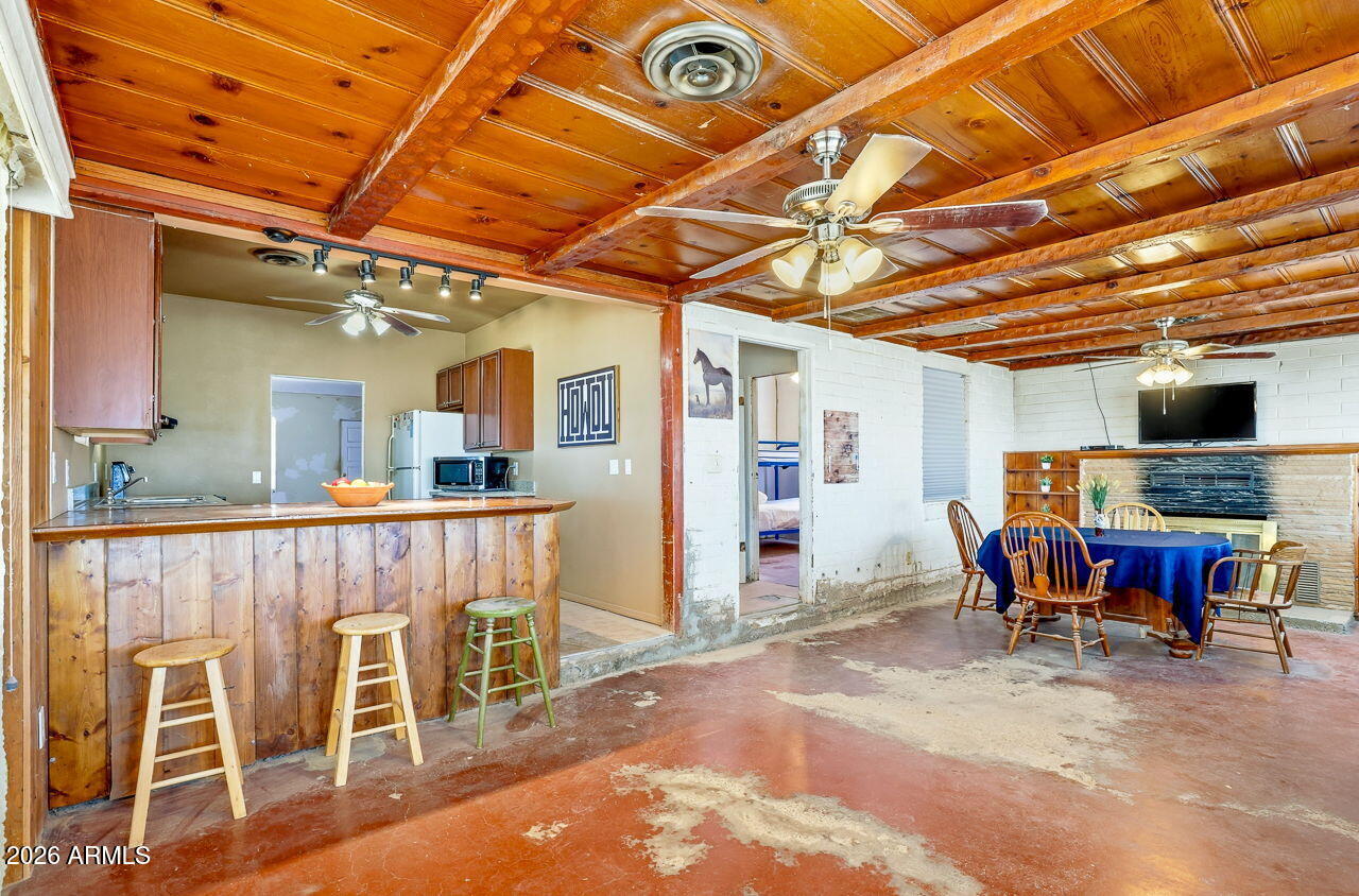 3384 East Cornman Road Casa Grande, AZ 85194 - Photo 34 of 58 a view of a dining room with furniture window and wooden floor