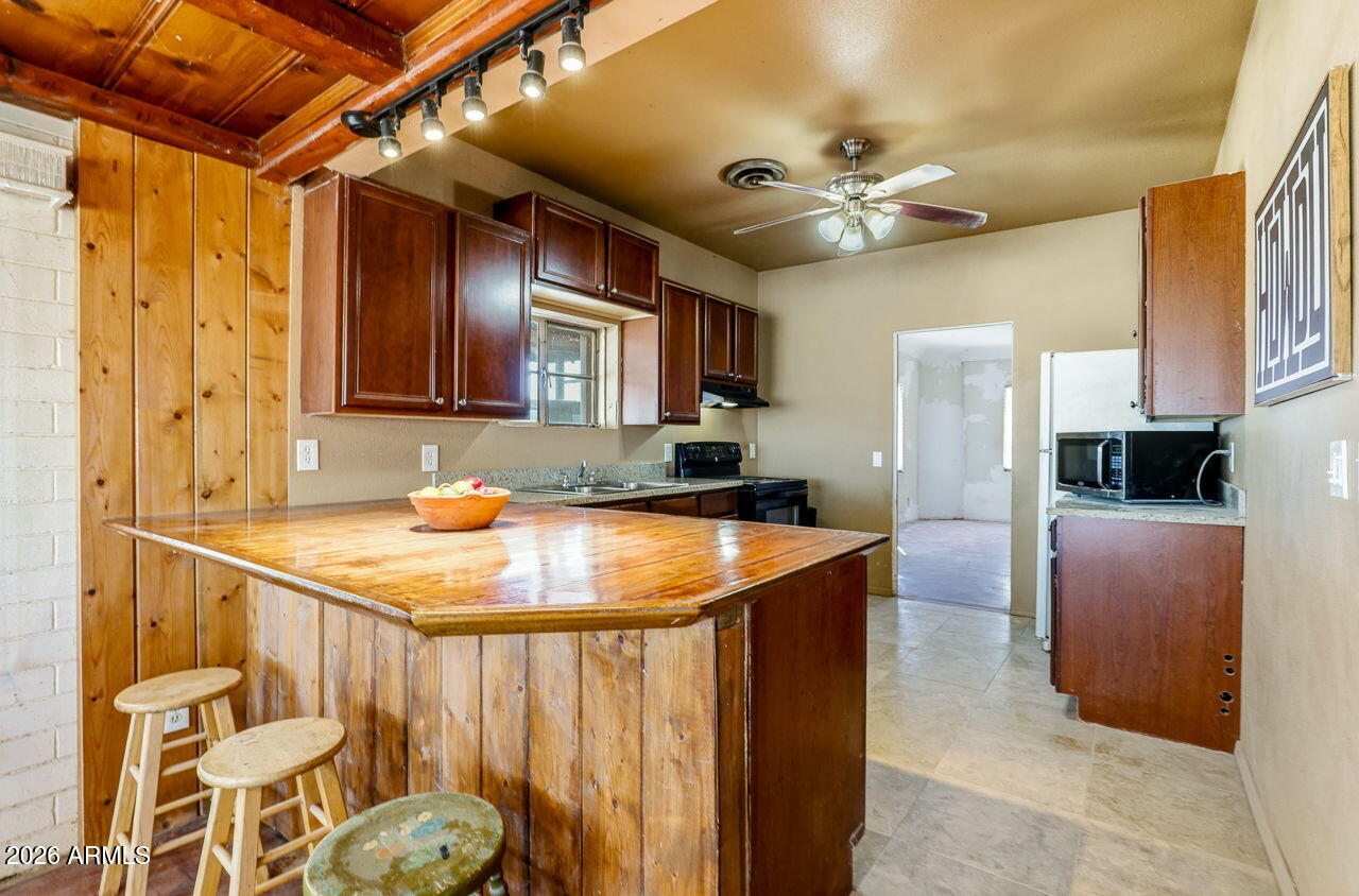 3384 East Cornman Road Casa Grande, AZ 85194 - Photo 38 of 58 a kitchen with stainless steel appliances granite countertop a sink and a refrigerator