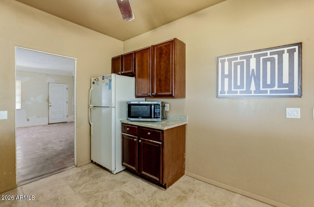 3384 East Cornman Road Casa Grande, AZ 85194 - Photo 39 of 58 a kitchen with stainless steel appliances granite countertop a refrigerator and a stove