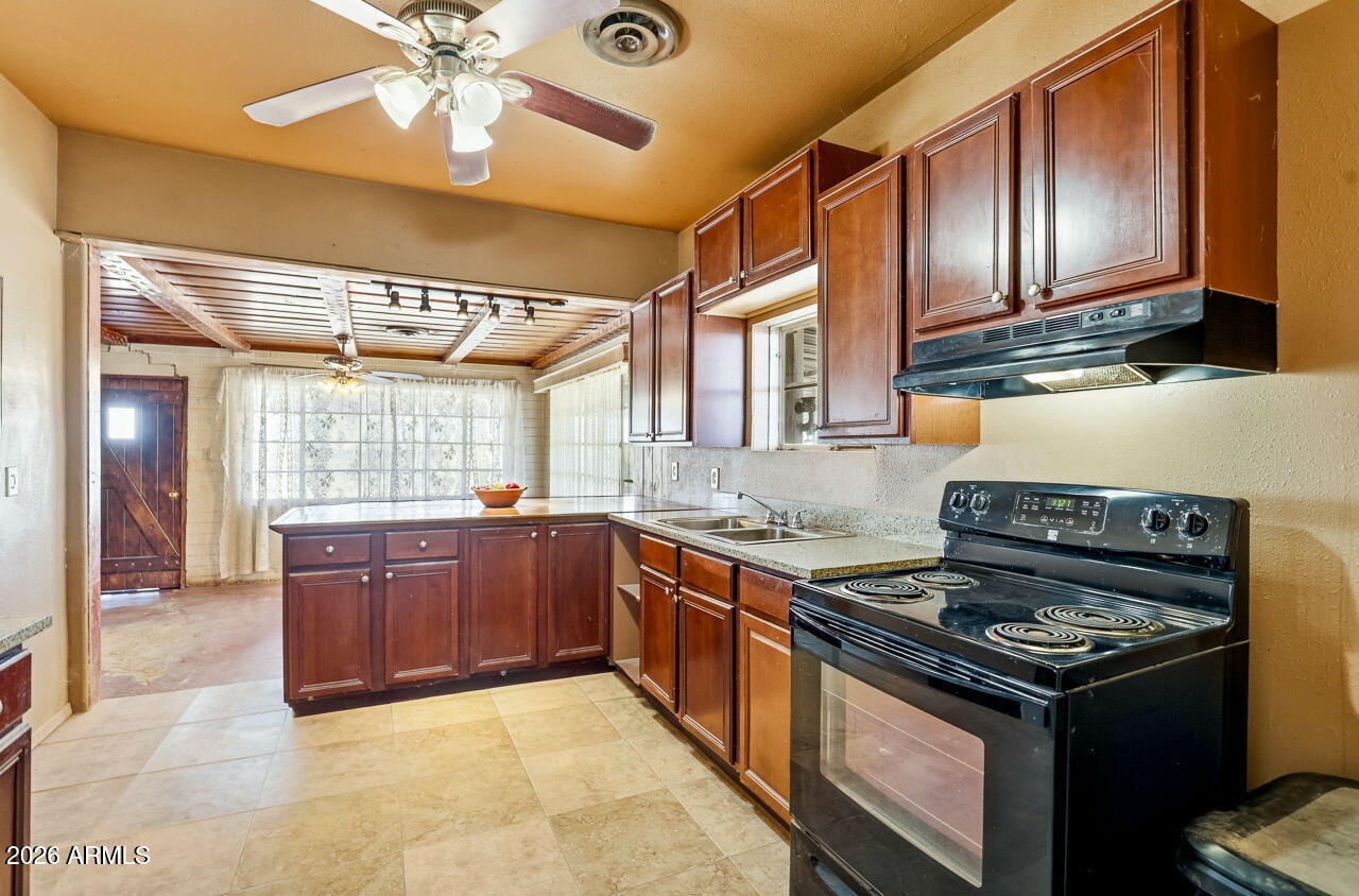 3384 East Cornman Road Casa Grande, AZ 85194 - Photo 41 of 58 a kitchen with stainless steel appliances granite countertop a stove and a sink