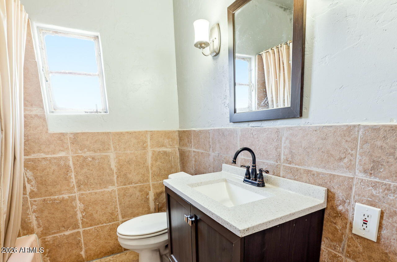 3384 East Cornman Road Casa Grande, AZ 85194 - Photo 44 of 58 a bathroom with a sink toilet and a mirror