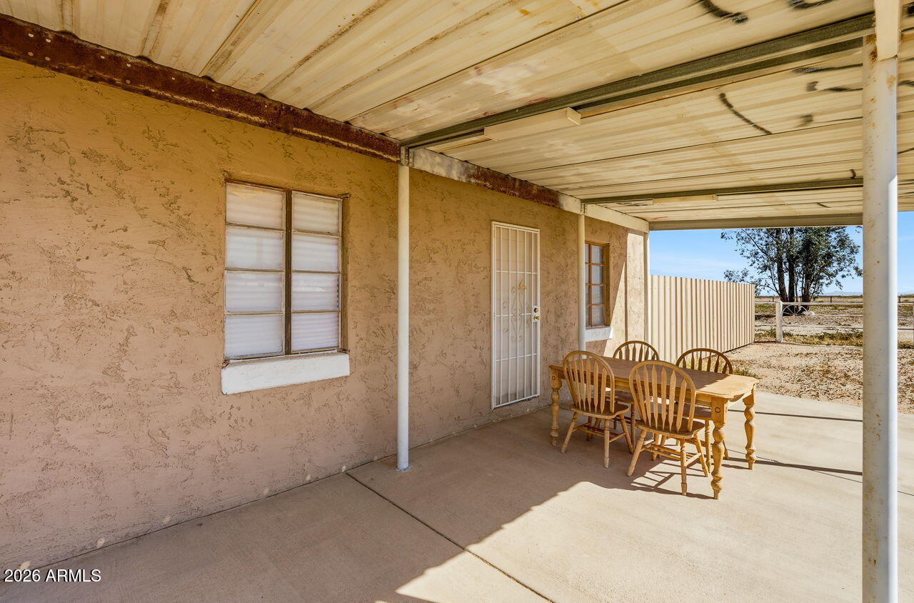 3384 East Cornman Road Casa Grande, AZ 85194 - Photo 53 of 58 a view of a patio with table and chairs and wooden floor