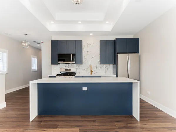 a kitchen with stainless steel appliances a refrigerator stove and microwave