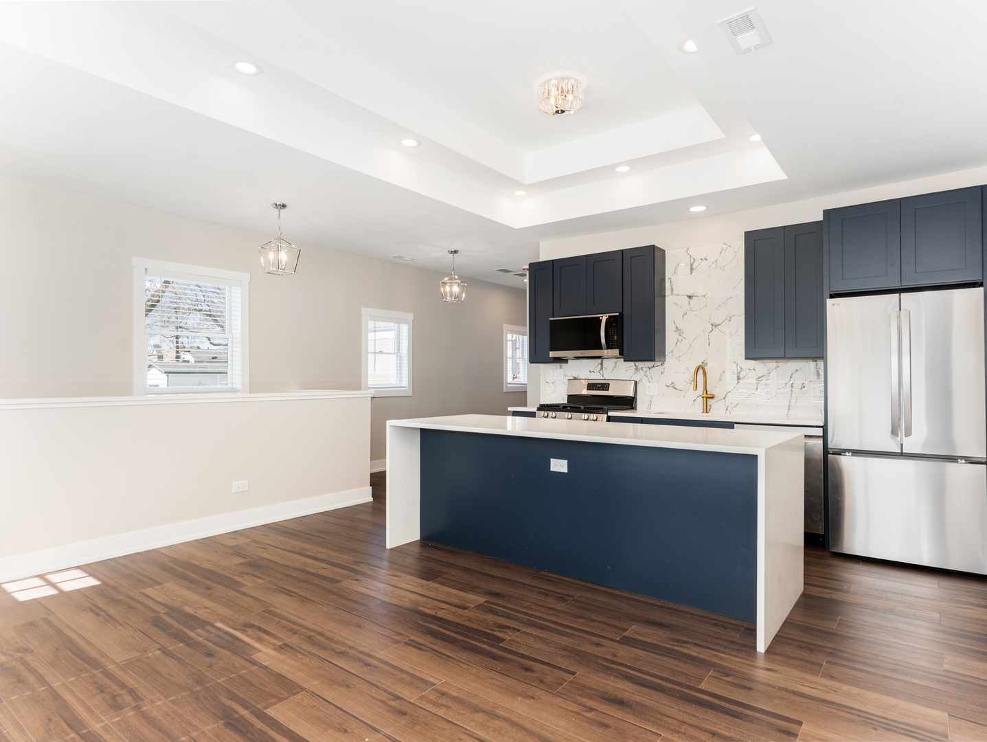 638 West 47th Street Chicago, IL 60609 - Photo 9 of 24 a kitchen with stainless steel appliances kitchen island granite countertop a refrigerator a sink dishwasher a stove with white cabinets and wooden floor