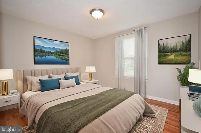 a bedroom with a bed and a painting on the wall