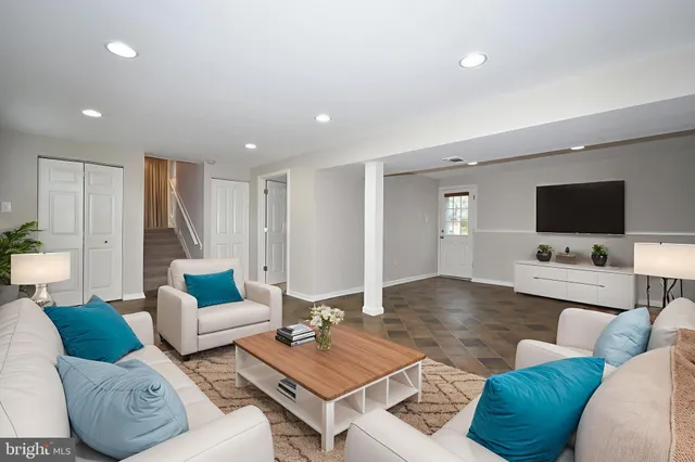 a living room with furniture and a flat screen tv