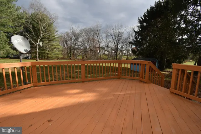a view of balcony with wooden floor and fence