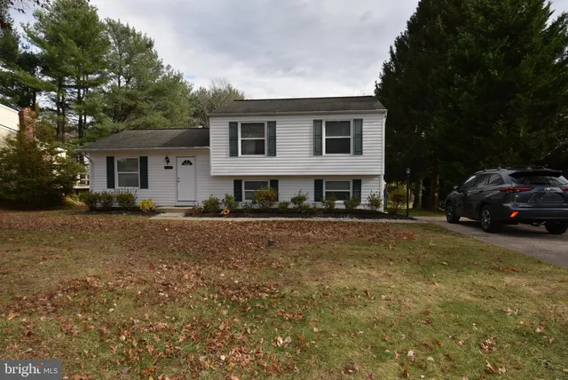 a view of a house with a bed and a yard