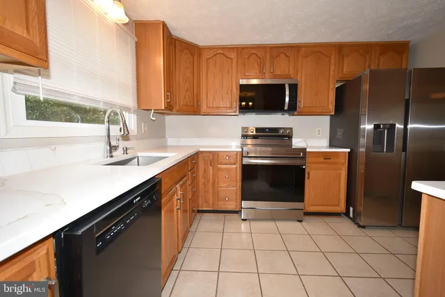 a kitchen with a sink stove and microwave