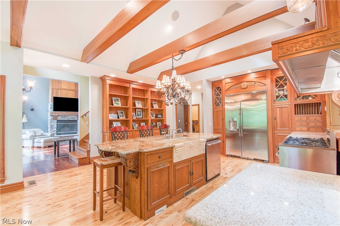 6868 River Styx Road Medina, OH 44256 - Photo 13 of 35 The gourmet kitchen is the heart of this home and the main gathering area for guests & family, featuring S/S appliances, granite counters, a massive island w a fabulous prep sink, double skylights, and vaulted ceilings.