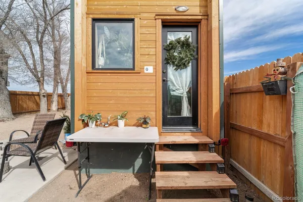 a balcony with furniture and a potted plant