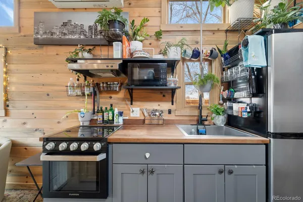 a kitchen with a sink and a stove top oven