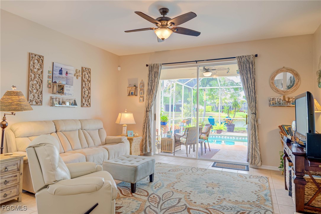 9005 Falcon Pointe Loop Fort Myers, FL 33912 - Photo 11 of 39 a living room with furniture and a large window with garden view