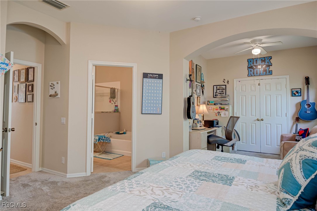 9005 Falcon Pointe Loop Fort Myers, FL 33912 - Photo 16 of 39 a bedroom with a bed and wooden floor