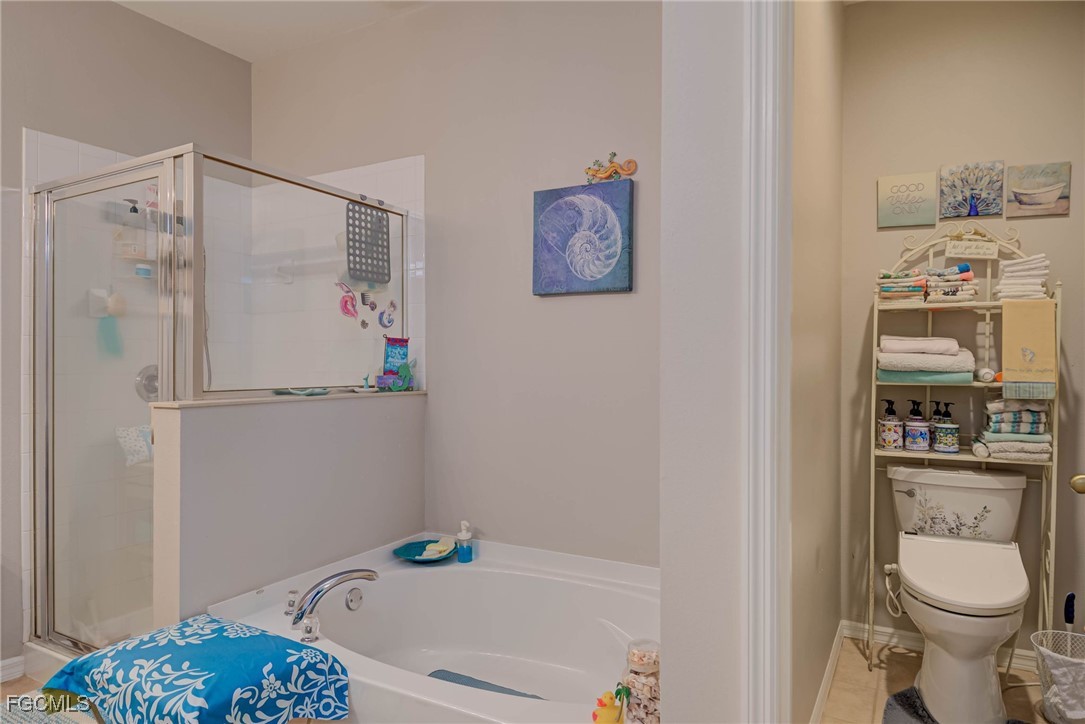9005 Falcon Pointe Loop Fort Myers, FL 33912 - Photo 20 of 39 a bathroom with a sink a toilet and a shower curtain