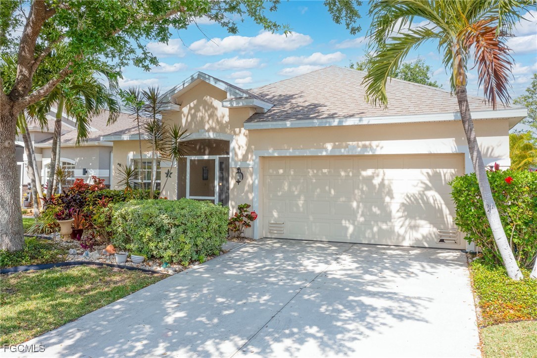 9005 Falcon Pointe Loop Fort Myers, FL 33912 - Photo 2 of 39 a front view of house with yard and green space
