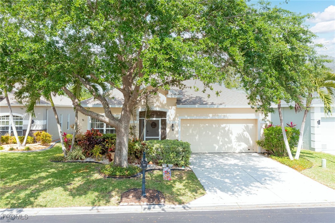 9005 Falcon Pointe Loop Fort Myers, FL 33912 - Photo 29 of 39 a front view of a house with garden