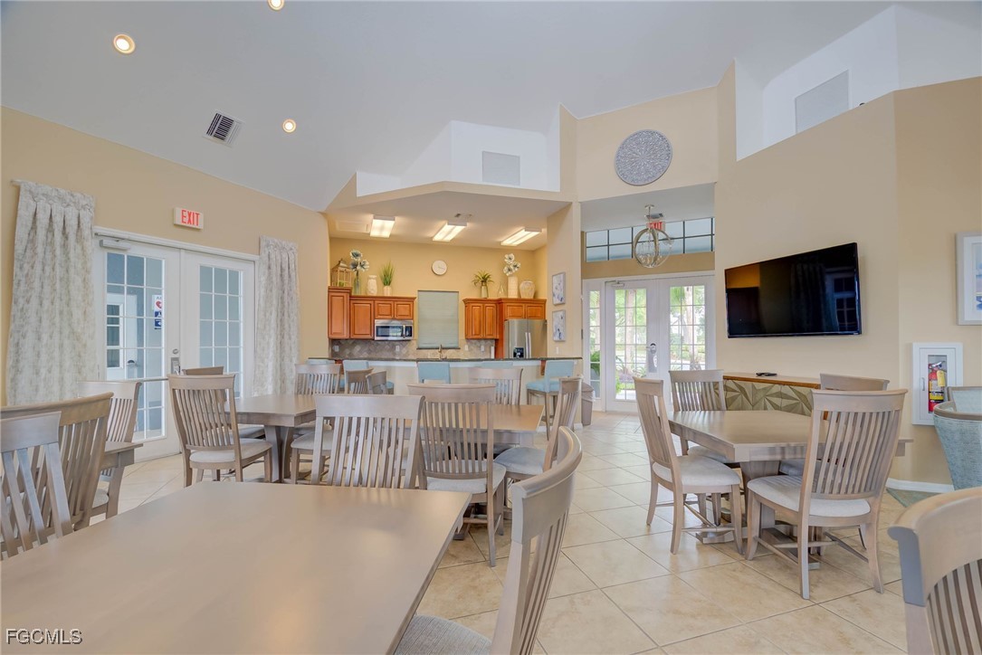 9005 Falcon Pointe Loop Fort Myers, FL 33912 - Photo 36 of 39 a view of a dining room with furniture window and wooden floor