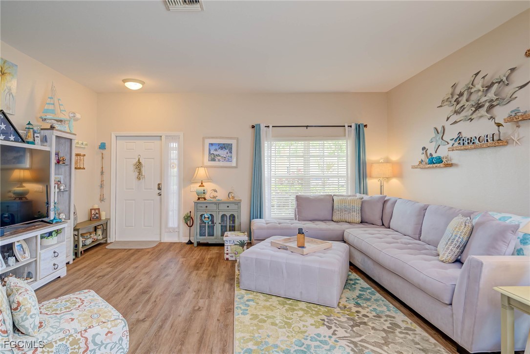 9005 Falcon Pointe Loop Fort Myers, FL 33912 - Photo 6 of 39 a living room with furniture and a flat screen tv