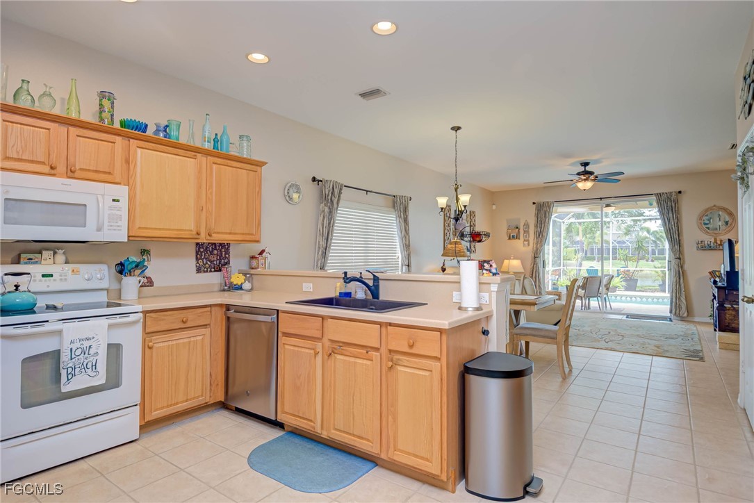 9005 Falcon Pointe Loop Fort Myers, FL 33912 - Photo 7 of 39 a kitchen with a sink stove and cabinets